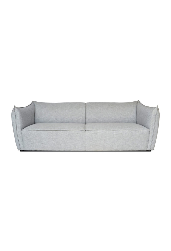 Elegant Sofa with Soft Lines Fully Upholstered in a Soft Light Grey Fabric with Self-Piping Edges on White Background