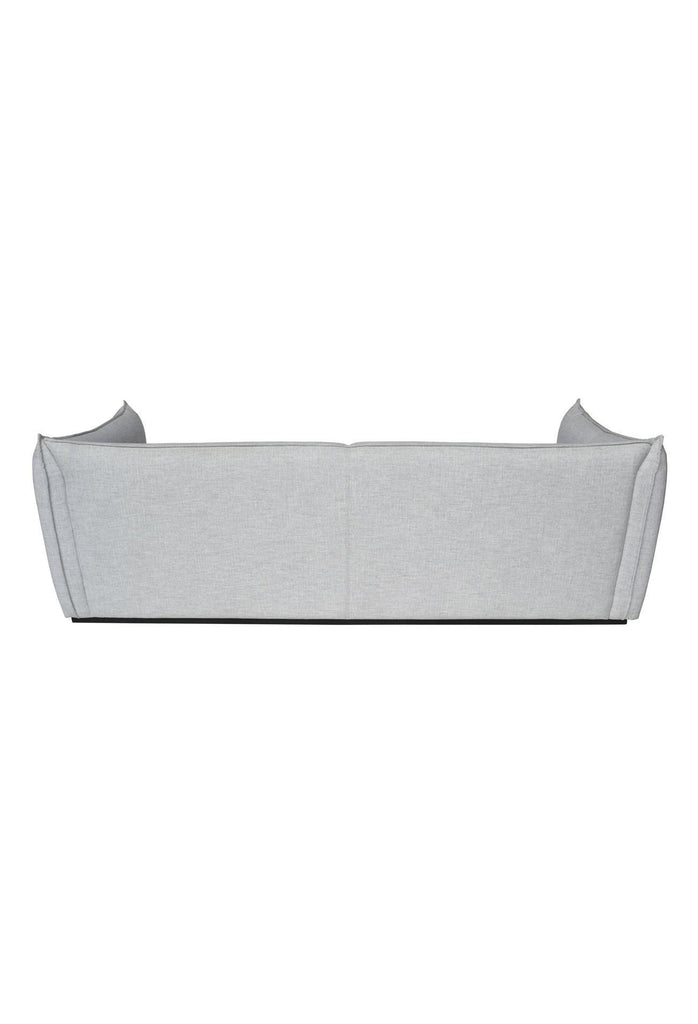 Elegant Sofa with Soft Lines Fully Upholstered in a Soft Light Grey Fabric with Self-Piping Edges on White Background