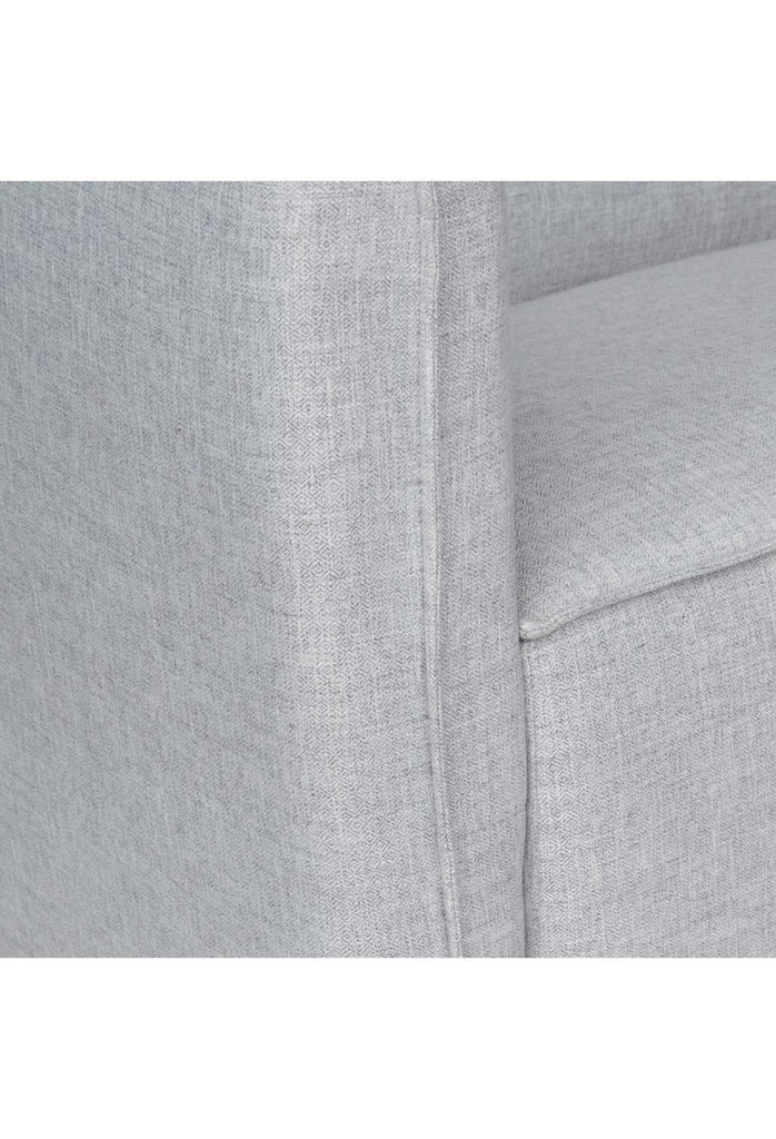 Elegant Sofa with Soft Lines Fully Upholstered in a Soft Light Grey Fabric with Self-Piping Edges on White Background