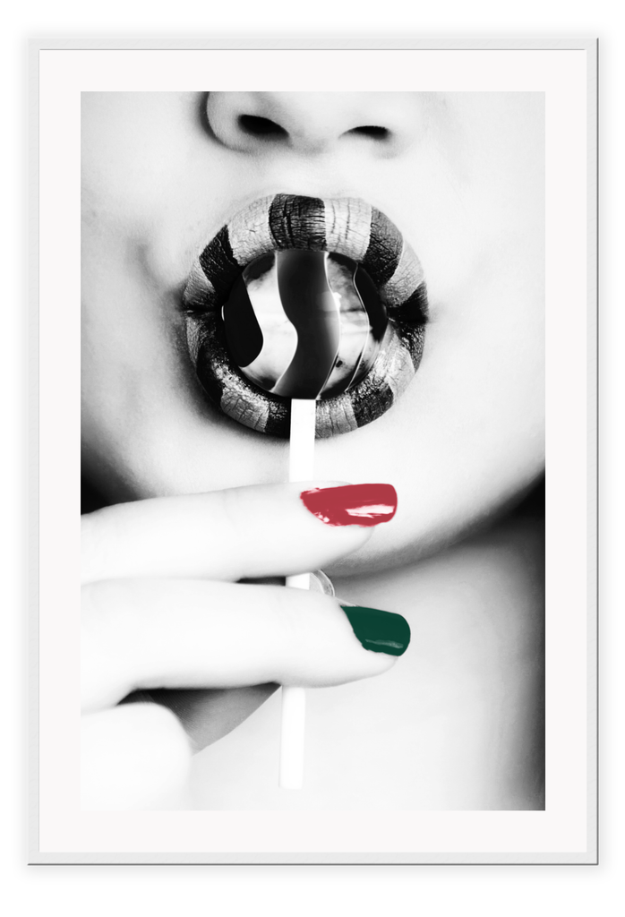Black and white modern print featuring a woman sucking a lollypop with one green one red finger nail and striped lipstick.