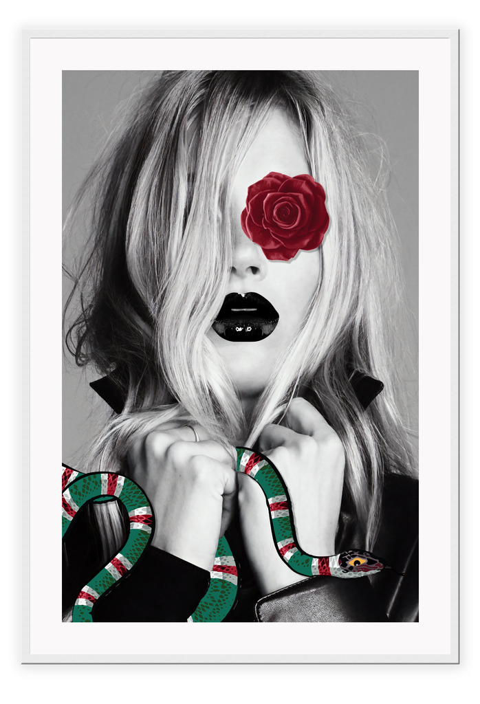 Fashion print Kate Moss model black and white with red rose over one eye holding a green and red gucci snake. 