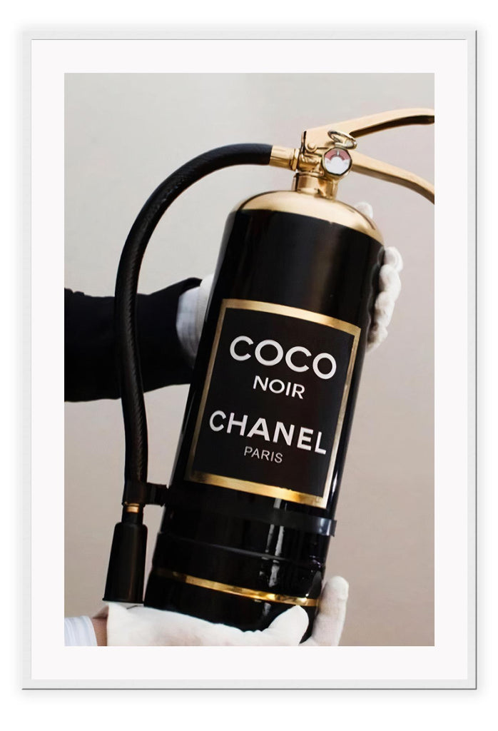 Gold, black and white fire fashion extinguisher with Chanel logo and hand with glove holding