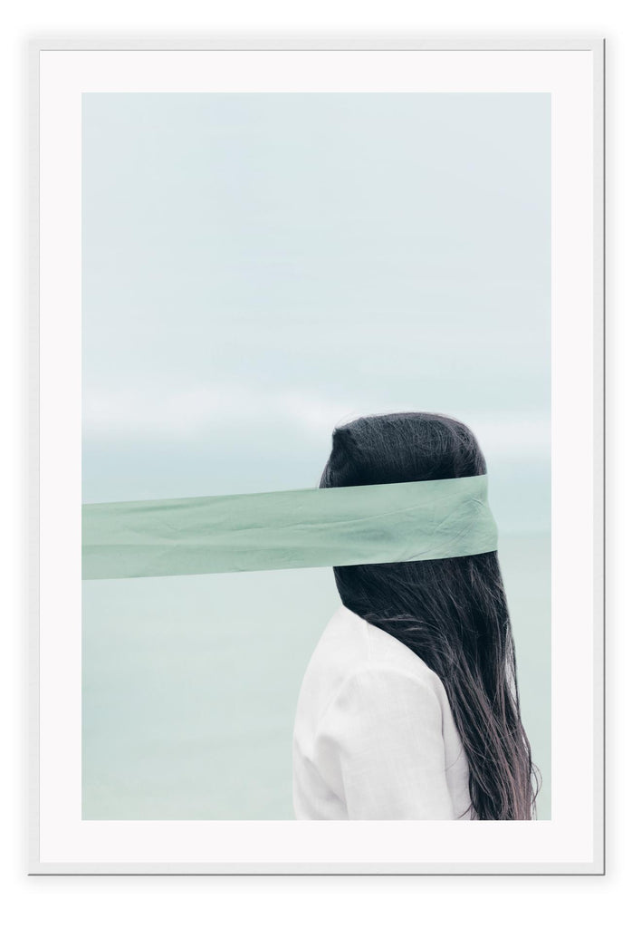 Photography of woman by the ocean wearing a blindfold with light blue tones and dark brown hair 
