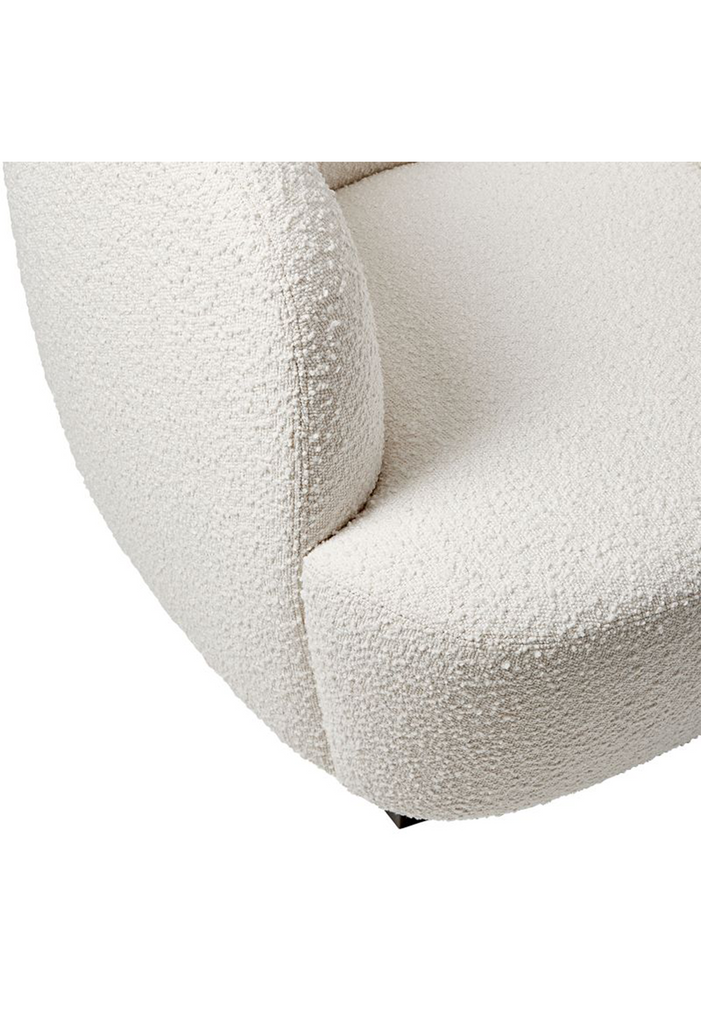 Modern curved tub style armchair upholstered in cream white boucle with black feet on a white background